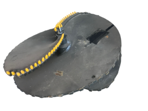 Circular black naval mine with yellow detonators along the rim (isolated).