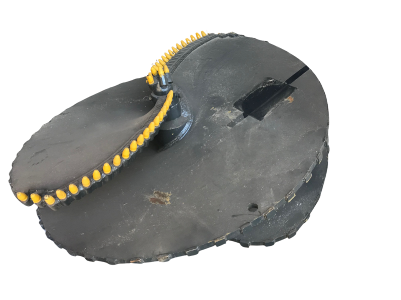 Circular black naval mine with yellow detonators along the rim (isolated).