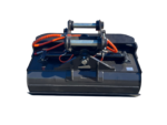 Front view of a heavy-duty hydraulic bucket attachment with orange hoses and dual cylinder arms on a dark loader.