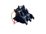 Industrial hydraulic grapple attachment (claw) with orange hoses for heavy machinery on a black background.