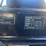 Close-up of two metal engine nameplates on a dark engine block, one labeled Important Engine Information and Korea Approval as the main focus on the left side.